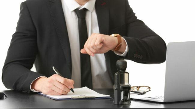 Male lawyer working with document in office